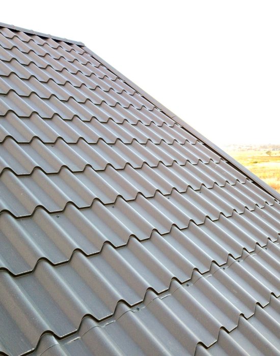 Close up of new house roof structure covered with metal tile sheets