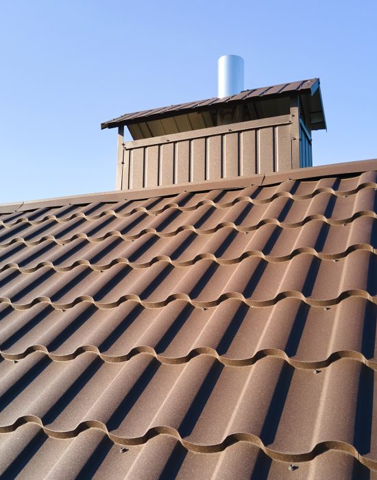 Closeup of house roof top covered with metallic shingles Closeup of house roof top covered with metallic shingles